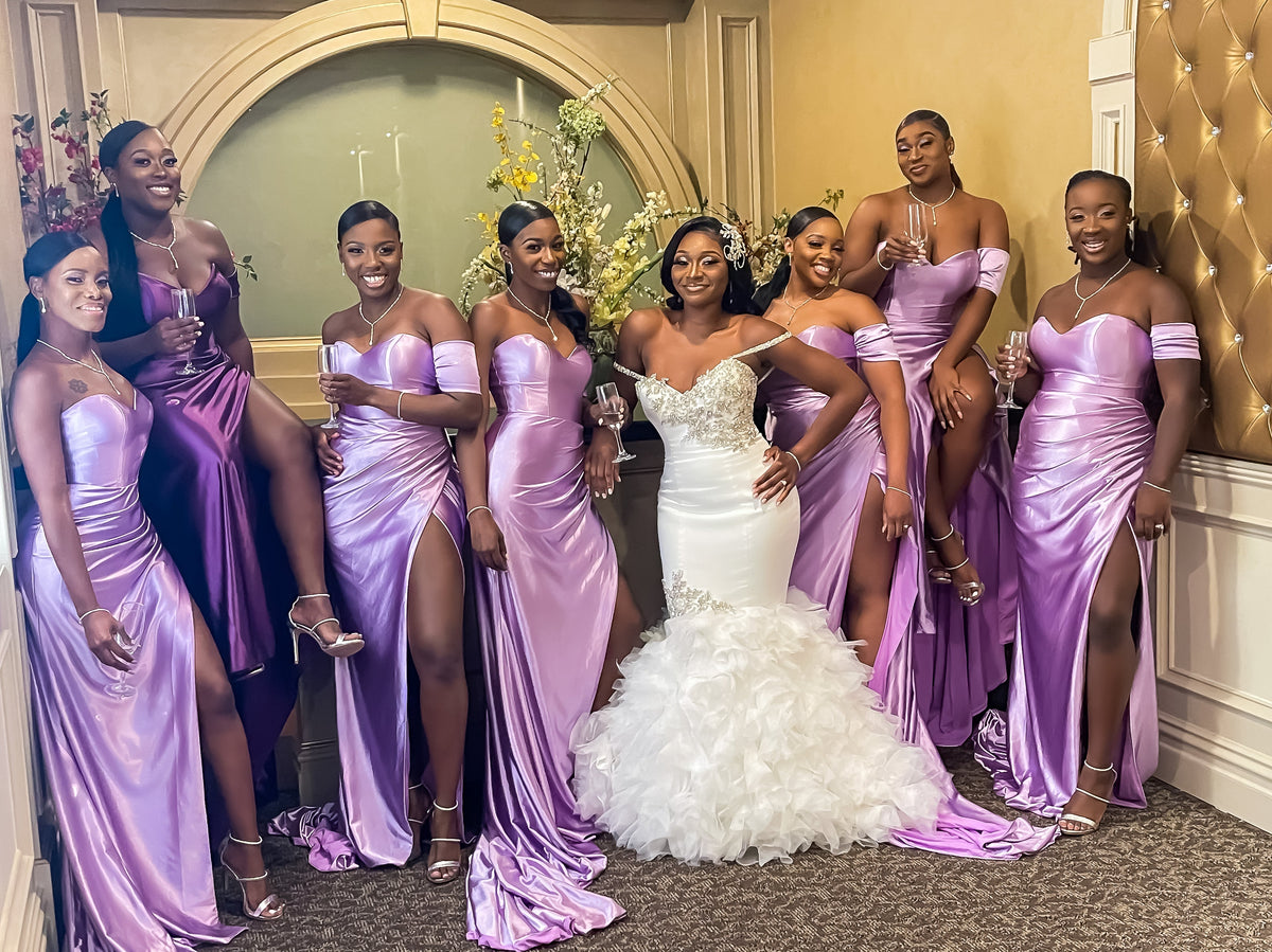 Bridal party of petite and plus size women in fitted mermaid bridesmaid dresses that are sexy. The Maid of Honor and Matron of Honor match the rest of the party in different fitted mermaid bridesmaid dresses that stretch and have leg slits.
