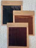 Pleated metallic fabric swatches in navy, copper and burgundy