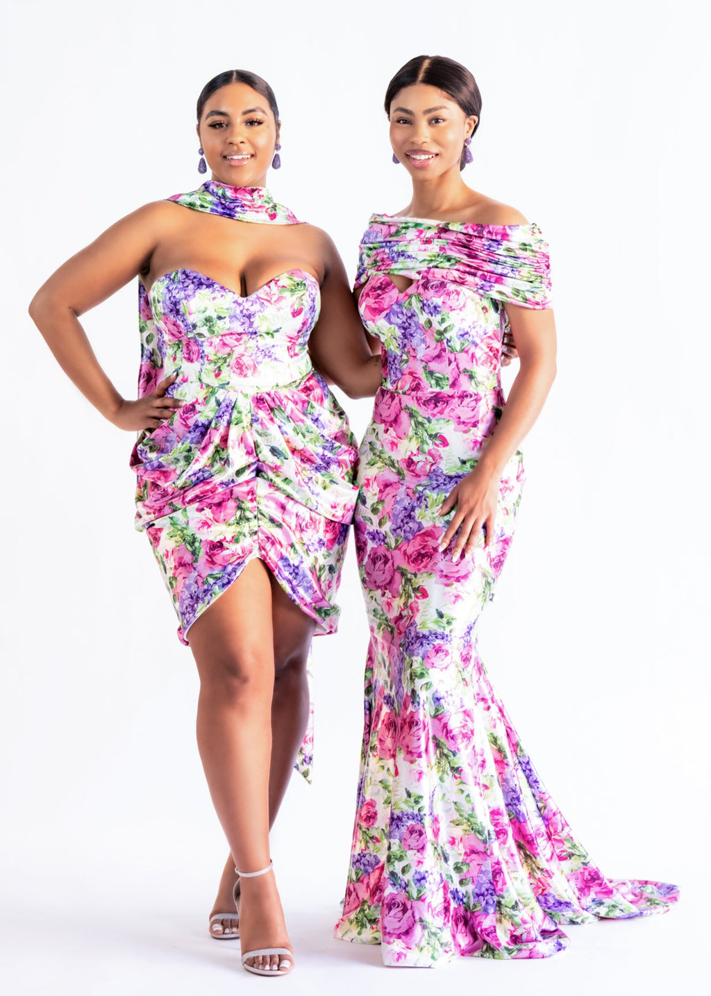 Two bridesmaids in coordinating pink floral print dresses, Livvy draped mini and a floor-length mermaid style