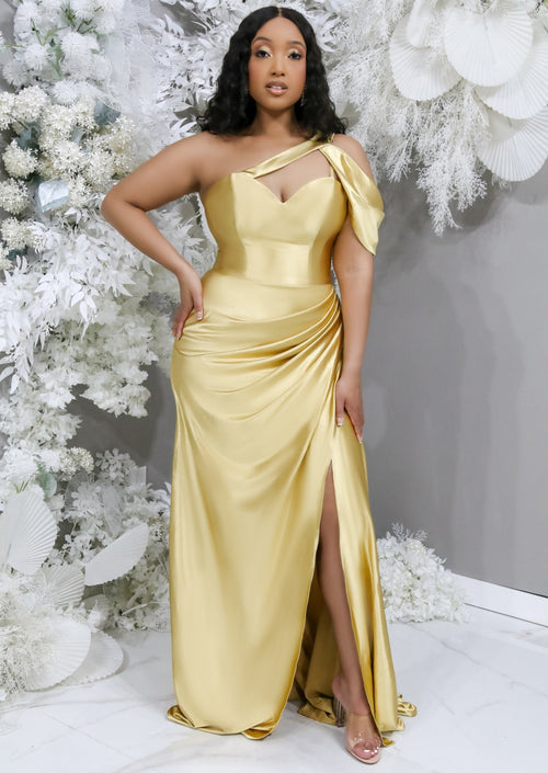 Gold fitted stretch satin bridesmaid dress with one shoulder detailing, keyhole neckline, ruching at the hip and slit at the leg on plus size curvy model