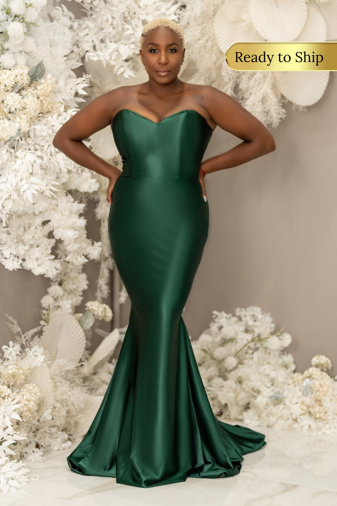 Plus size black bridesmaid wearing a sexy strapless emerald green mermaid bridesmaid dress with stretch to flaunt curves