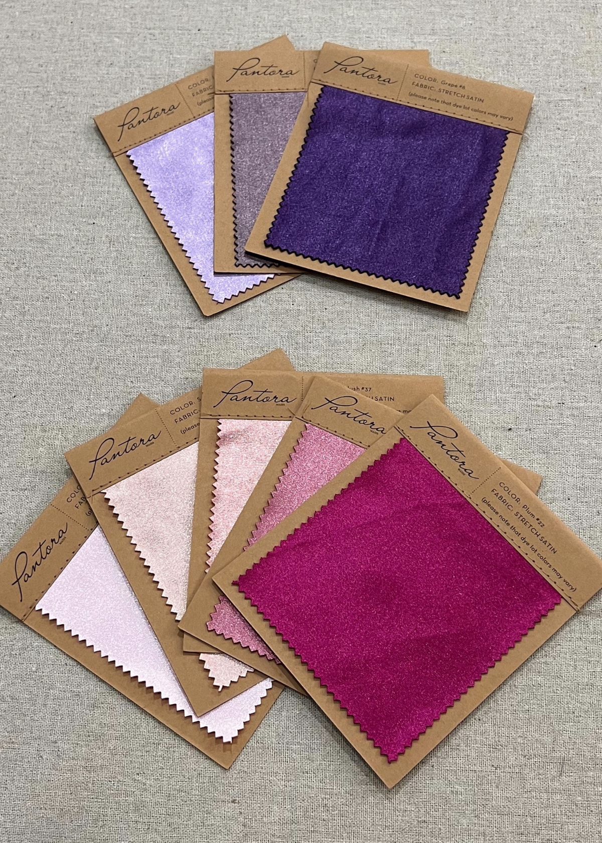 Stretch satin swatch cards in purple, lilac, blush and fuchsia