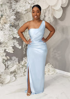 Curvy petite bridesmaid wearing a one-shoulder column bridesmaid dress with stretch. This dress has a slit at the leg and ruching throughout to flatter all body types and is shown on a black model.