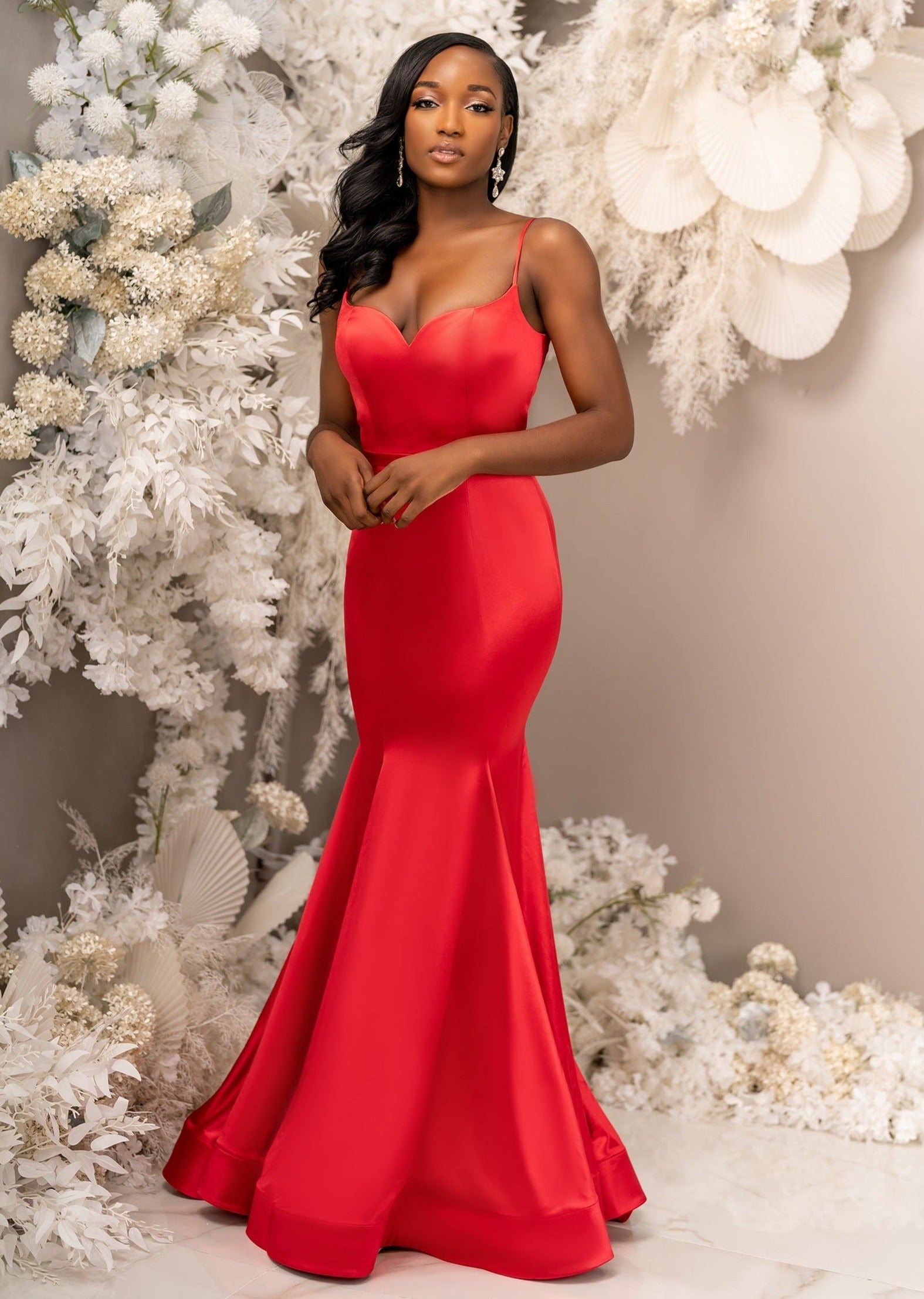 Sexy mermaid bridesmaid dress with spaghetti straps and a sweetheart neckline cinches the waist and shows off the hips with stretch throughout the dress. Shown in bright red on a black model.