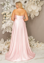 Light pink flowy A-Line bridesmaid dress with sweetheart neckline bridesmaid dress with belted waist and skirt slit on plus-size model - back view
