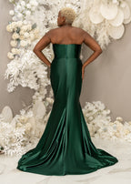 Plus size black bridesmaid wearing a strapless emerald green mermaid bridesmaid dress with stretch to flaunt curves - back view