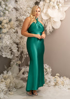 Bridesmaid wearing a classic fitted bridesmaid dress with open back and twisted halter neckline. Shown in emerald green on a plus size model.