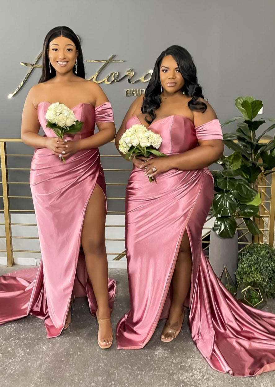Plus size black models wearing a stretch satin bridesmaid dress with sweetheart neckline, leg slit, and sweeping train