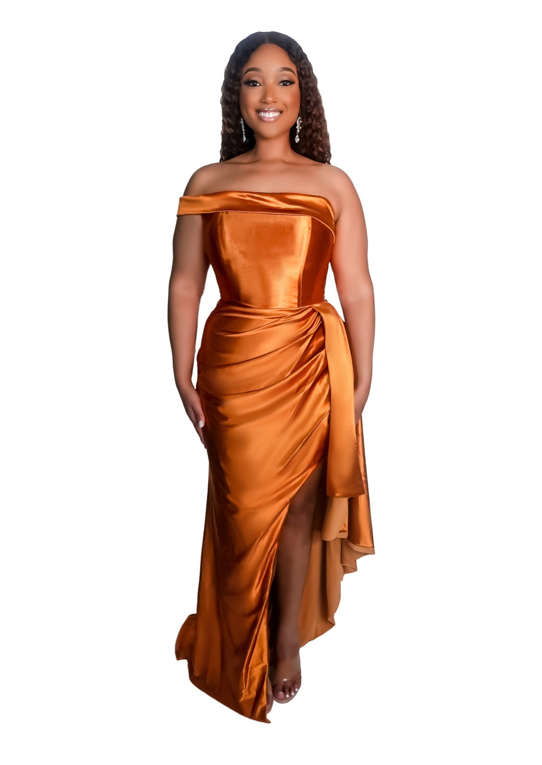 Plus size bridesmaid in asymmetrical fitted stretch satin bridesmaid dress with ruching at the waist and through the skirt and an off-the-shoulder strap. This style is designed to flatter and complement all body types. Shown in burnt orange on a curvy black model.